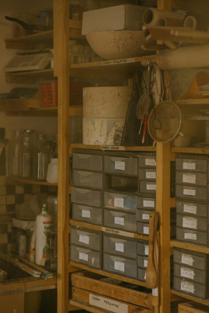 Storage boxes stacked neatly against the wall with other knick knacks around | Benefits of owning a shed | Rooser's Amish Shed's, WV