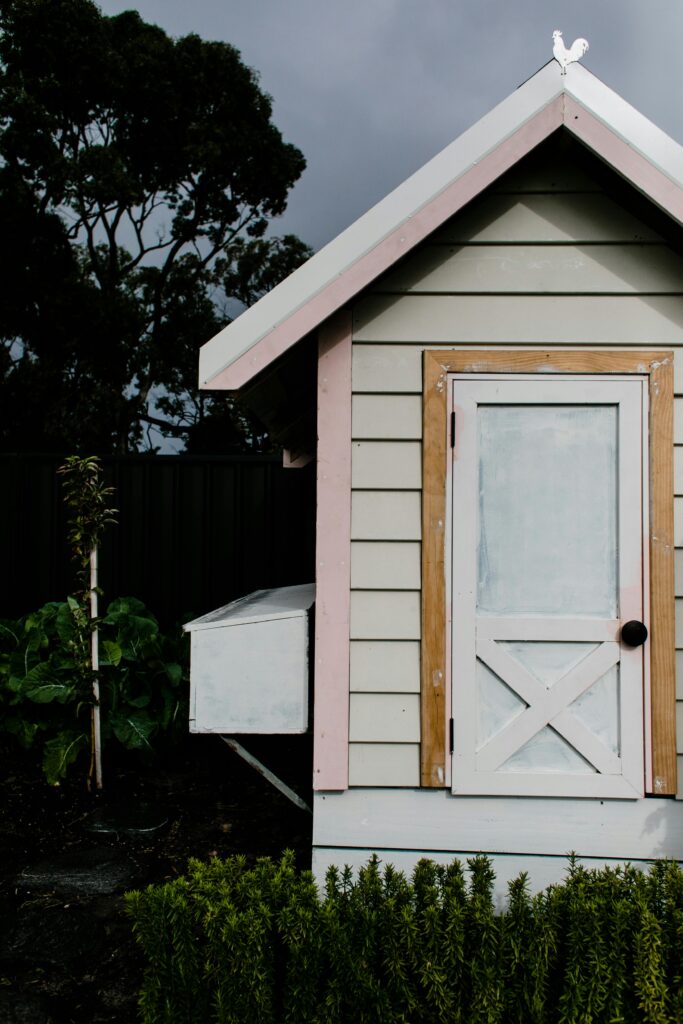 White shed with a yellow trimmed door | Amish Structures | Rooster's Amish Sheds | WV