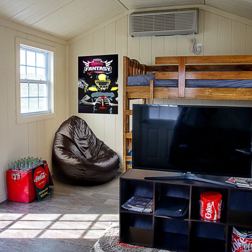 Man cave with a tv, bean bag, chair, mini fridge, and bunk beds | Residential Storage Building | Roosters Amish Sheds