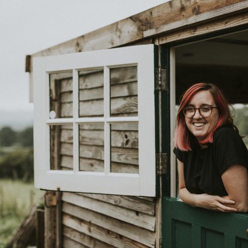 Happy woman in a rural wooden house
