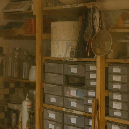 Storage boxes stacked neatly against the wall with other knick knacks around | Benefits of owning a shed | Rooser's Amish Shed's, WV