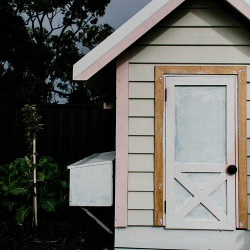 White shed with a yellow trimmed door | Amish Structures | Rooster's Amish Sheds | WV